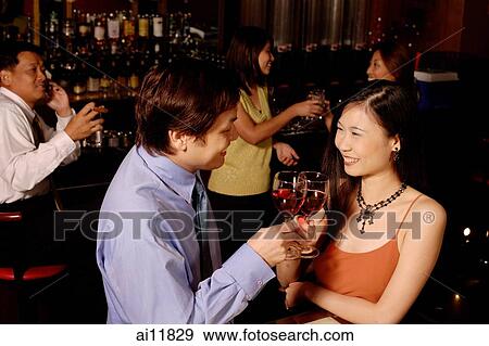 Stock Photo - Men and women at bar. Fotosearch