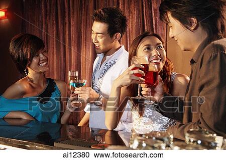 Men and women having drinks at bar View Large Photo Image Stock Image - Men and women having drinks at bar. Fotosearch