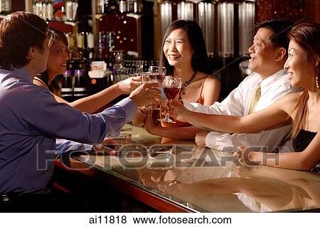 Men and women sitting around table toasting View Large Photo Image Stock Photo - Men and women sitting around table toasting. Fotosearch