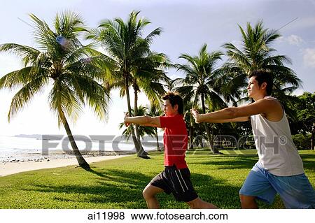 Men doing stretching exercises in park, leg outstretched View Large Photo Image Stock Photo - Men doing stretching exercises in park, leg outstretched. Fotosearch