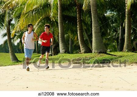 Men jogging along beach, side by side View Large Photo Image Stock Photo - Men jogging along beach, side by side. Fotosearch