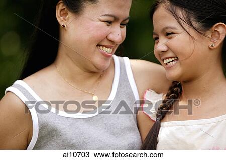 Mother and daughter looking at each other, smiling View Large Photo Image Stock Image - Mother and daughter looking at each other, smiling. Fotosearch