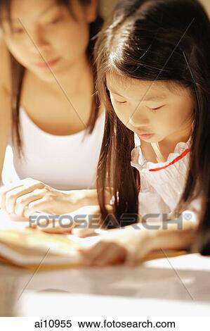 Mother and daughter, side by side, looking at magazine View Large Photo Image Stock Photography - Mother and daughter, side by side, looking at magazine. Fotosearch