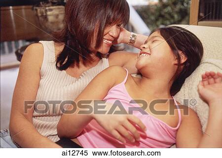 Mother and daughter sitting and smiling at each other View Large Photo Image Stock Photography - Mother and daughter sitting and smiling at each other. Fotosearch
