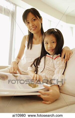 Mother and daughter, sitting side by side, looking at camera, smiling View Large Photo Image Stock Image - Mother and daughter, sitting side by side, looking at camera, smiling. Fotosearch