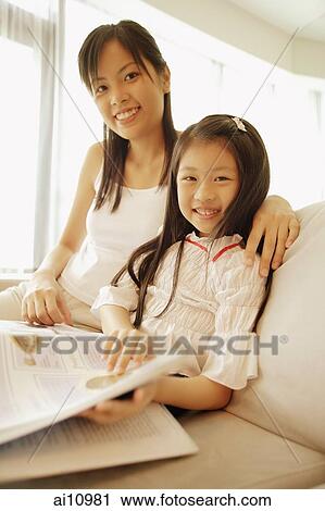 Mother and daughter, sitting side by side, looking at camera View Large Photo Image Stock Image - Mother and daughter, sitting side by side, looking at camera. Fotosearch