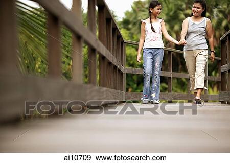 Mother and daughter, walking hand in hand View Large Photo Image Stock Photo - Mother and daughter, walking hand in hand. Fotosearch