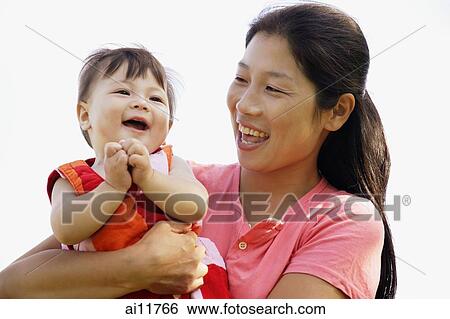 Mother carrying baby girl, bonding View Large Photo Image Stock Photograph - Mother carrying baby girl, bonding. Fotosearch