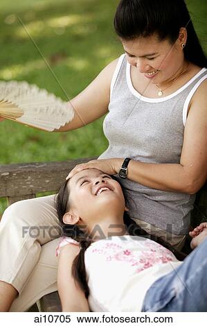 Mother fanning her daughter. View Large Photo Image Stock Photography - Mother fanning her daughter.. Fotosearch