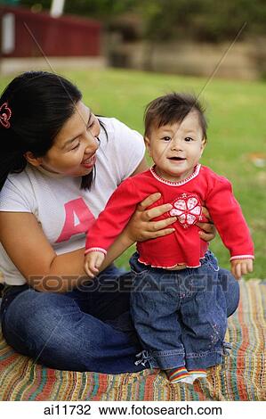 Mother holding up baby girl View Large Photo Image Stock Image - Mother holding up baby girl. Fotosearch