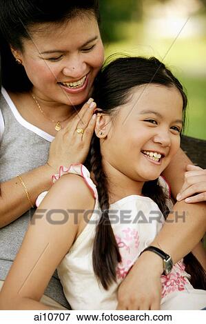 Mother hugging daughter, laughing View Large Photo Image Stock Photo - Mother hugging daughter, laughing. Fotosearch