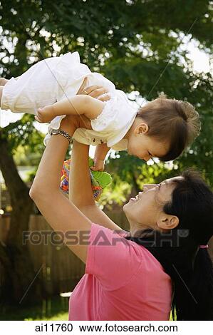 Mother lifting baby up, bonding View Large Photo Image Stock Image - Mother lifting baby up, bonding. Fotosearch