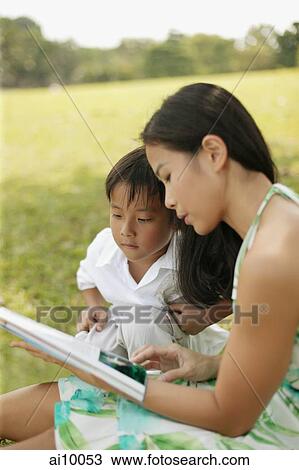 Mother reading to her son View Large Photo Image Stock Image - Mother reading to her son. Fotosearch