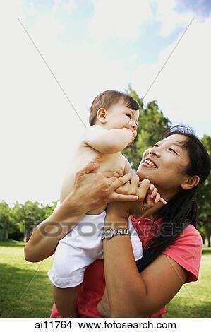 Picture - Mother with baby girl, bonding. Fotosearch