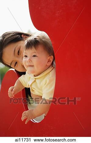 Mother with baby girl in playground View Large Photo Image Stock Image - Mother with baby girl in playground. Fotosearch