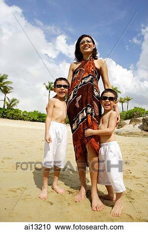 Mother with two boys, standing on beach, portrait View Large Photo Image Stock Image - Mother with two boys, standing on beach, portrait. Fotosearch