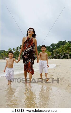 Mother with two boys, walking on beach, portrait View Large Photo Image Stock Image - Mother with two boys, walking on beach, portrait. Fotosearch