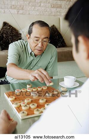 Older man playing Chinese chess with younger man View Large Photo Image Stock Photography - Older man playing Chinese chess with younger man. Fotosearch