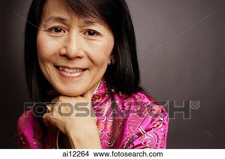 Picture - Portrait of a mature woman, hand on chin. Fotosearch