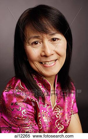 Portrait of a mature woman, smiling at camera View Large Photo Image Stock Photography - Portrait of a mature woman, smiling at camera. Fotosearch
