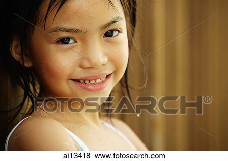 Stock Photo - Portrait of a young girl, looking at camera. Fotosearch