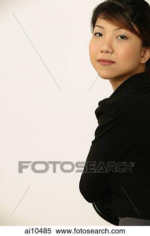 Portrait of a young woman, looking at camera View Large Photo Image Stock Photography - Portrait of a young woman, looking at camera. Fotosearch