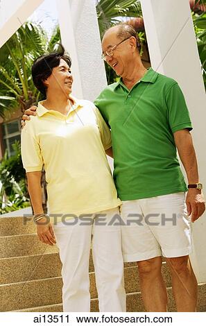 Senior couple standing, looking at each other View Large Photo Image Stock Image - Senior couple standing, looking at each other. Fotosearch
