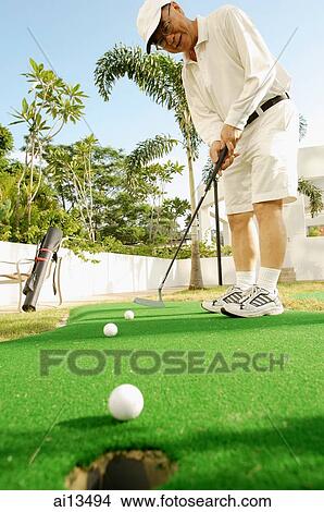 Senior man holding golf club, playing golf View Large Photo Image Picture - Senior man holding golf club, playing golf. Fotosearch