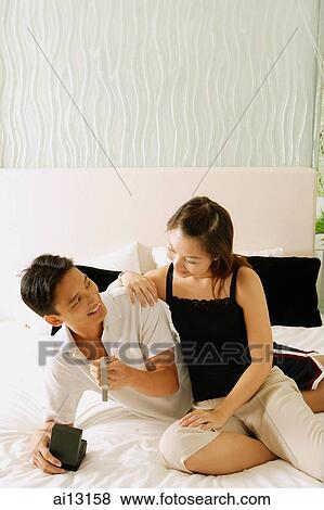 Senior woman receiving red packet from man facing her View Large Photo Image Stock Photo - Senior woman receiving red packet from man facing her. Fotosearch
