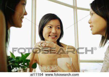 Sisters sitting, having coffee and talking View Large Photo Image Picture - Sisters sitting, having coffee and talking. Fotosearch