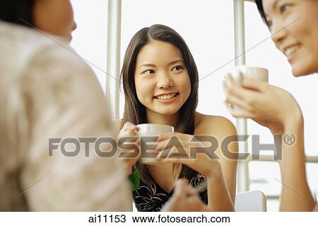Sisters sitting, having coffee and talking View Large Photo Image Stock Image - Sisters sitting, having coffee and talking. Fotosearch