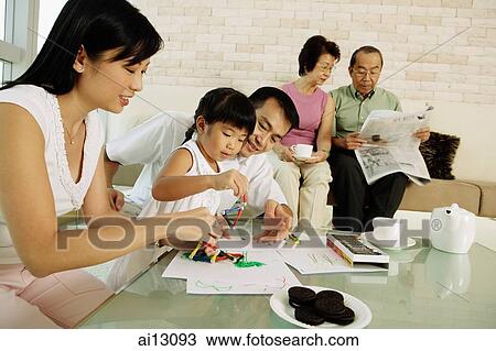 Three generation family in living room, grandparents reading, parents drawing with daughter View Large Photo Image Stock Image - Three generation family in living room, grandparents reading, parents drawing with daughter. Fotosearch