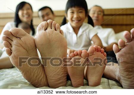 Three generation family on bed, focus on their feet View Large Photo Image Stock Image - Three generation family on bed, focus on their feet. Fotosearch