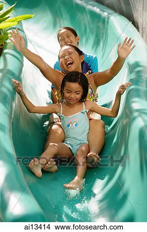 Three girls going down water slide, arms outstretched View Large Photo Image Picture - Three girls going down water slide, arms outstretched. Fotosearch