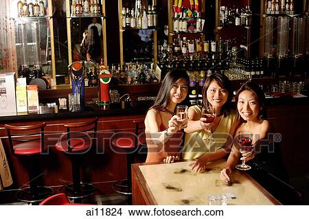 Three women holding wine glasses, looking at camera View Large Photo Image Picture - Three women holding wine glasses, looking at camera. Fotosearch