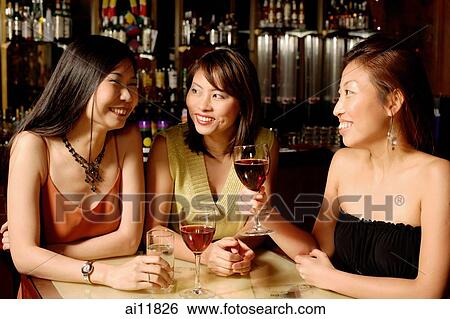 Stock Photograph - Three women holding wine glasses. Fotosearch