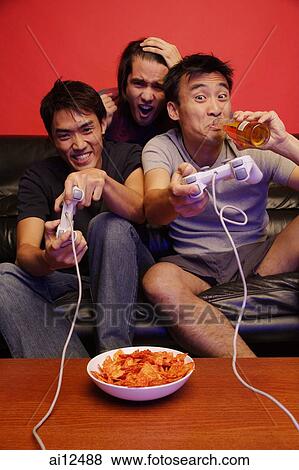 Three young men, with video games, beer and chips View Large Photo Image Stock Photo - Three young men, with video games, beer and chips. Fotosearch