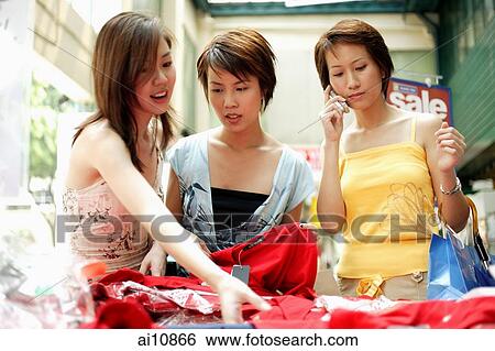 Three young women shopping View Large Photo Image Stock Photograph - Three young women shopping. Fotosearch