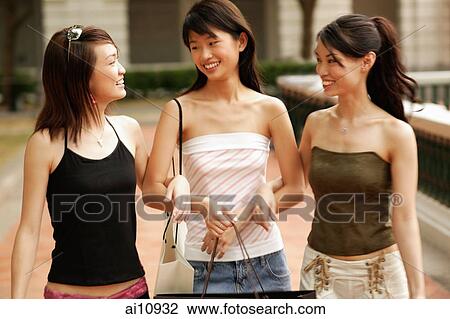 Three young women, walking arm in arm View Large Photo Image Stock Image - Three young women, walking arm in arm. Fotosearch