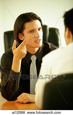 Two businessmen having a discussion View Large Photo Image Stock Photo - Two businessmen having a discussion. Fotosearch