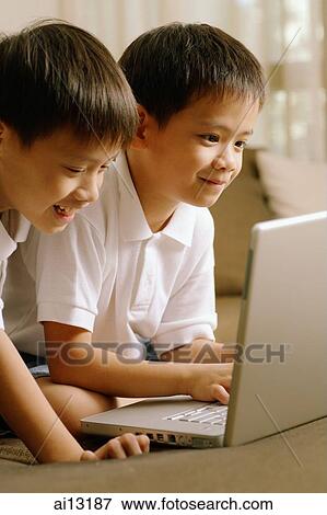 Stock Photo - Two children using laptop. Fotosearch