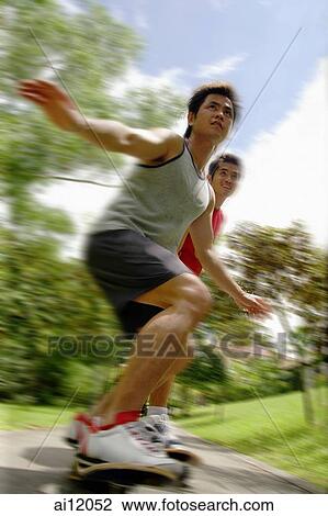 Stock Image - Two guys on skateboards. Fotosearch