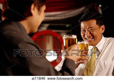Two men drinking beer together View Large Photo Image Stock Photograph - Two men drinking beer together. Fotosearch