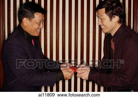 Two men exchanging business cards View Large Photo Image Stock Photo - Two men exchanging business cards. Fotosearch