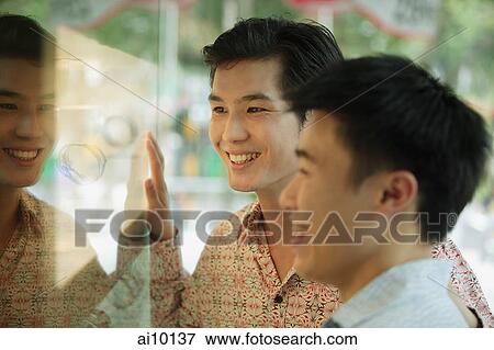 Two men in front of shop window, View Large Photo Image Stock Photo - Two men in front of shop window,. Fotosearch