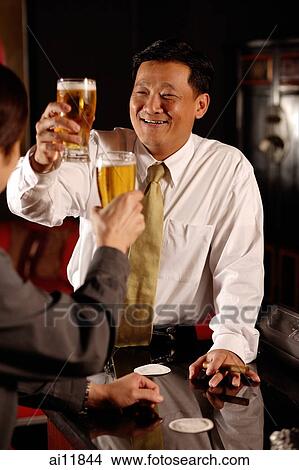 Two men raising beer glasses View Large Photo Image Picture - Two men raising beer glasses. Fotosearch