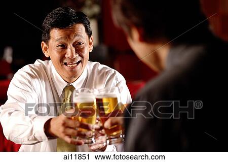 Two men toasting with beer glasses. View Large Photo Image Stock Image - Two men toasting with beer glasses.. Fotosearch