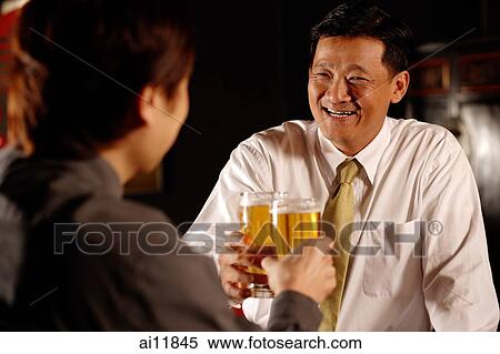 Stock Photography - Two men toasting with beer.. Fotosearch