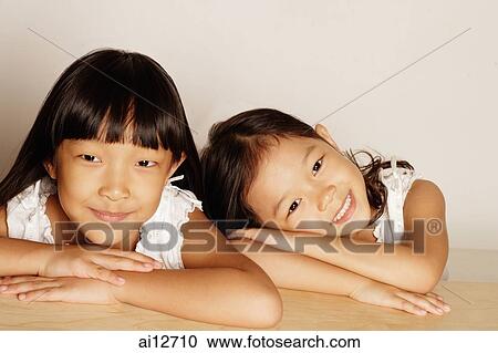 Two sister's side by side, looking at camera View Large Photo Image Stock Image - Two sister's side by side, looking at camera. Fotosearch