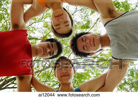 Two women and two men, arms around each other eyes closed View Large Photo Image Picture - Two women and two men, arms around each other eyes closed. Fotosearch